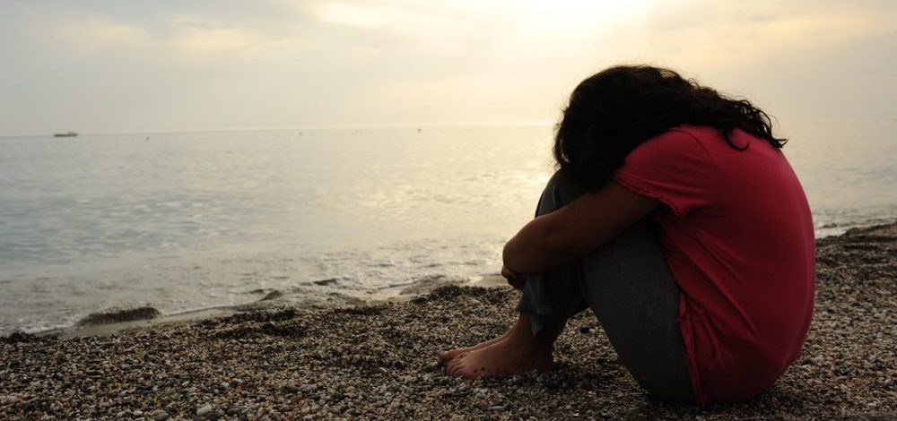 lonely-sad-girl-on-the-dark-beach-e1577738631728